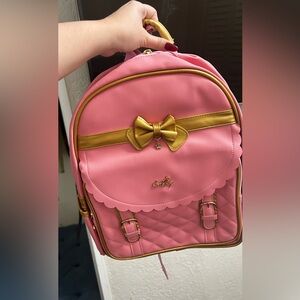 Pink backpack with gold details